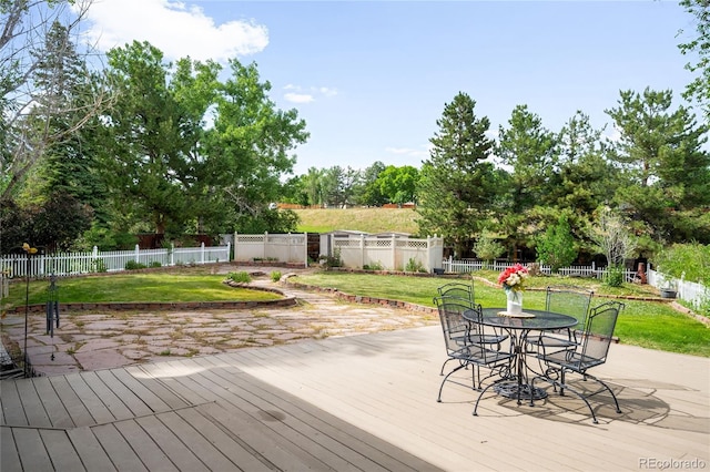 7603 W Coal Mine Pl, Littleton, CO 80128 - deck featuring outdoor dining area and view of wooded area