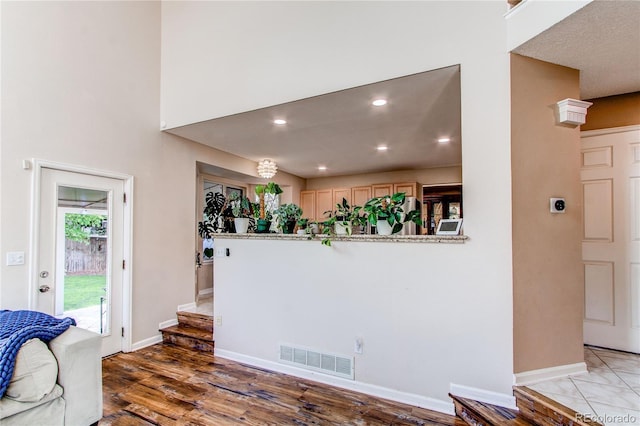 living room featuring light wood-style flooring, baseboards, and recessed lighting