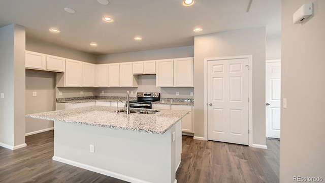 kitchen featuring electric range, dark wood-type flooring, recessed lighting, and white cabinets