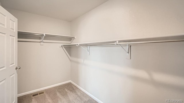 walk in closet with carpet floors and visible vents