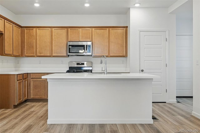 2116 Chambers Rd, Brighton, CO 80601 - kitchen featuring light wood-style flooring, light countertops, and appliances with stainless steel finishes