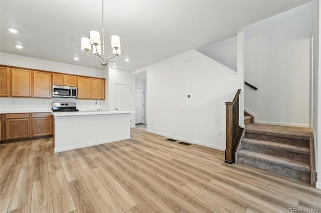 2116 Chambers Rd, Brighton, CO 80601 - kitchen featuring a sink, appliances with stainless steel finishes, visible vents, light wood-style floors, and recessed lighting