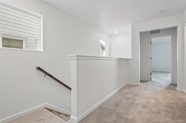 2116 Chambers Rd, Brighton, CO 80601 - hallway featuring baseboards, an upstairs landing, visible vents, and carpet