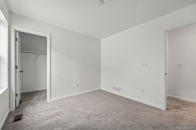 2116 Chambers Rd, Brighton, CO 80601 - unfurnished bedroom with visible vents, carpet, and a walk in closet