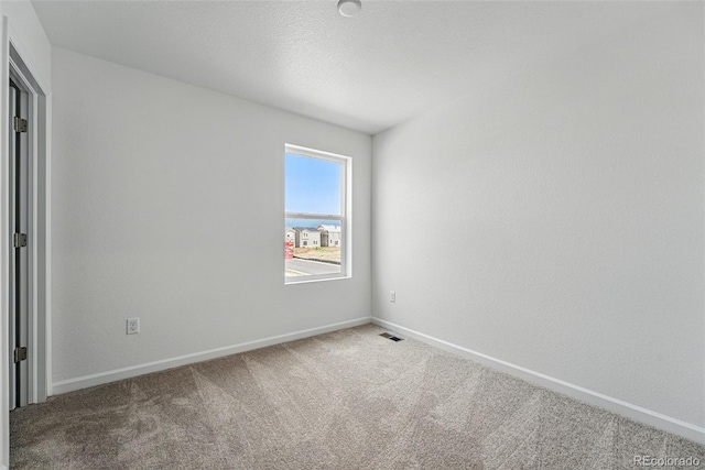 2116 Chambers Rd, Brighton, CO 80601 - carpeted spare room with visible vents and baseboards