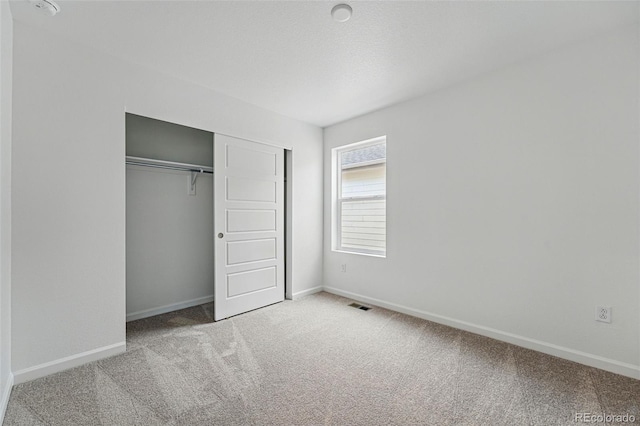 2116 Chambers Rd, Brighton, CO 80601 - unfurnished bedroom featuring carpet, visible vents, baseboards, and a closet