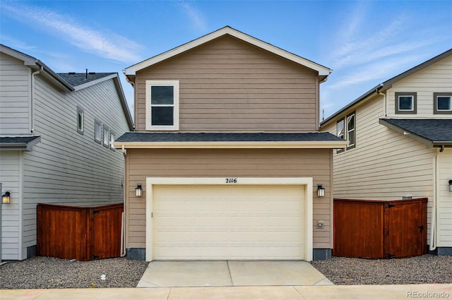 2116 Chambers Rd, Brighton, CO 80601 - view of front facade featuring an attached garage, driveway, and fence