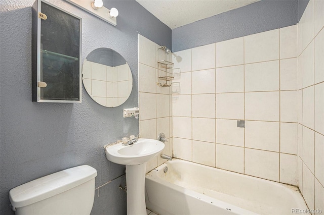 2280 S Decatur St, Denver, CO 80219 - full bathroom with a textured wall, toilet, and shower / tub combination