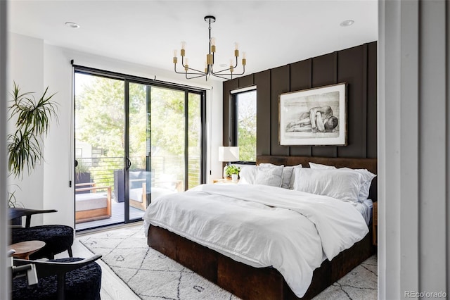 bedroom featuring a notable chandelier, access to exterior, and wooden walls