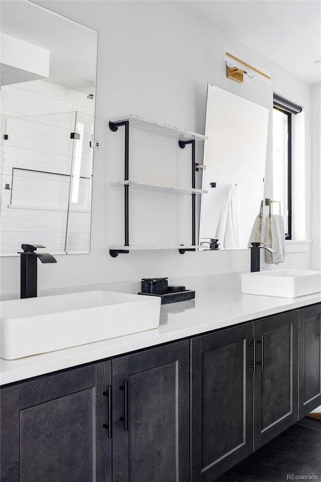 bathroom featuring a shower and vanity