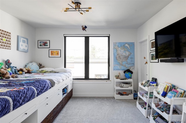 bedroom with a chandelier and carpet floors