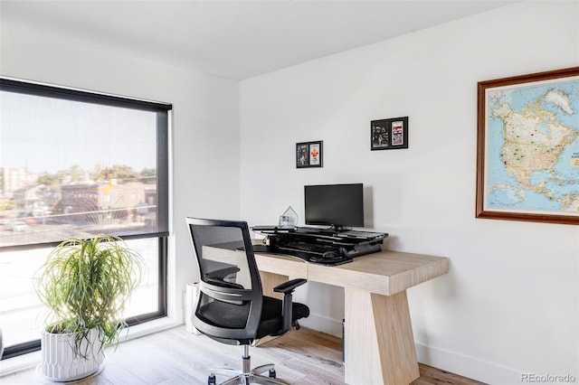 home office with hardwood / wood-style flooring