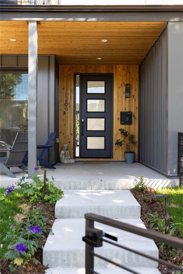 view of exterior entry featuring covered porch