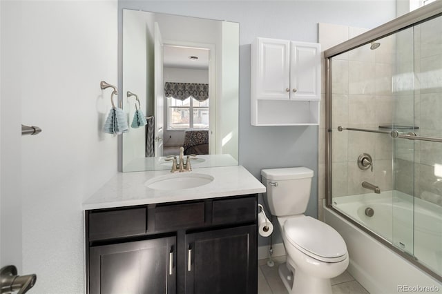 bathroom featuring vanity, toilet, shower / bath combination with glass door, and connected bathroom