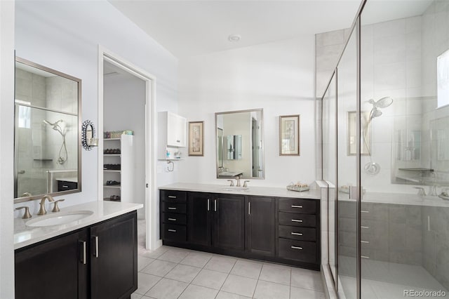 bathroom featuring tile patterned flooring, two vanities, a stall shower, and a sink