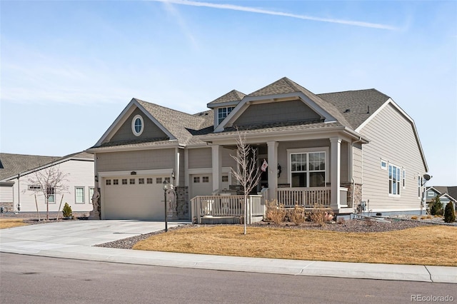 view of front of property with covered porch, concrete driveway, a garage, and a shingled roof