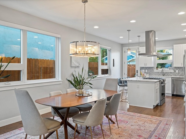 dining space featuring a chandelier, dark hardwood / wood-style floors, and sink