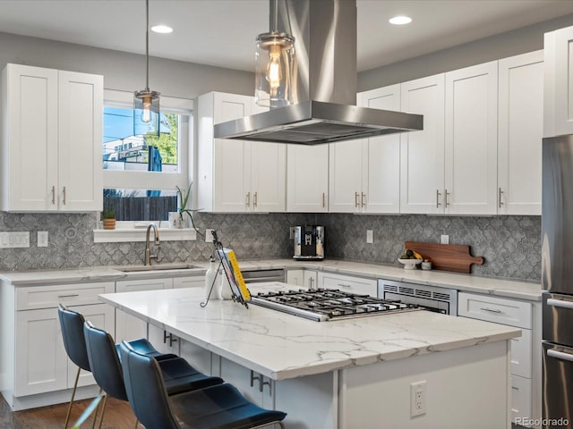 kitchen featuring white cabinetry, island range hood, a kitchen island, and pendant lighting