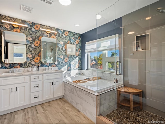 bathroom with vanity, plus walk in shower, and wood-type flooring