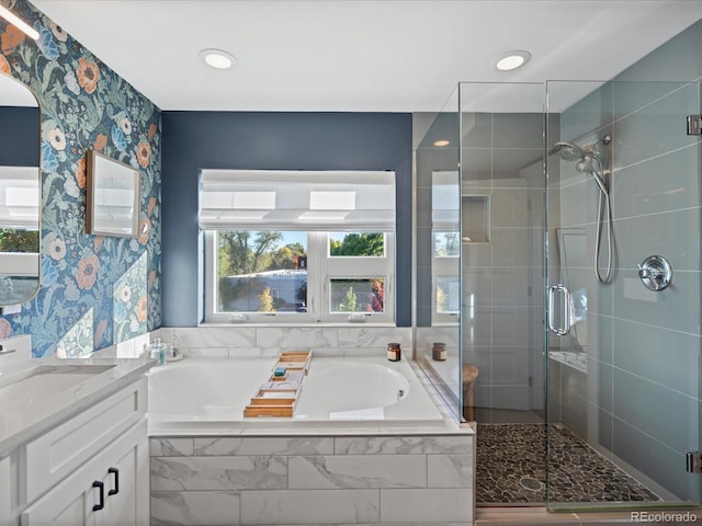 bathroom featuring separate shower and tub and vanity