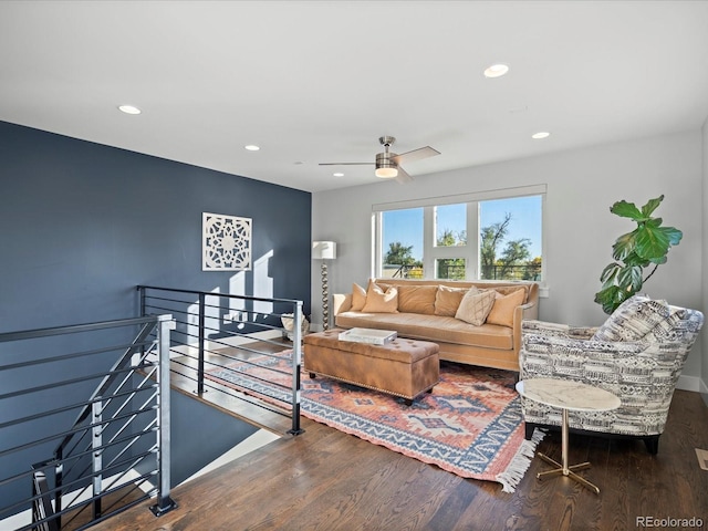 living room with ceiling fan and dark hardwood / wood-style flooring