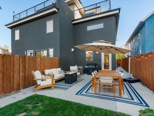 rear view of house featuring a balcony, an outdoor hangout area, and a patio