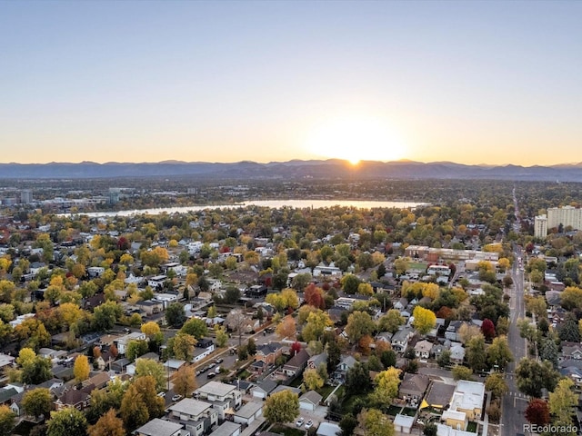 aerial view at dusk featuring a mountain view