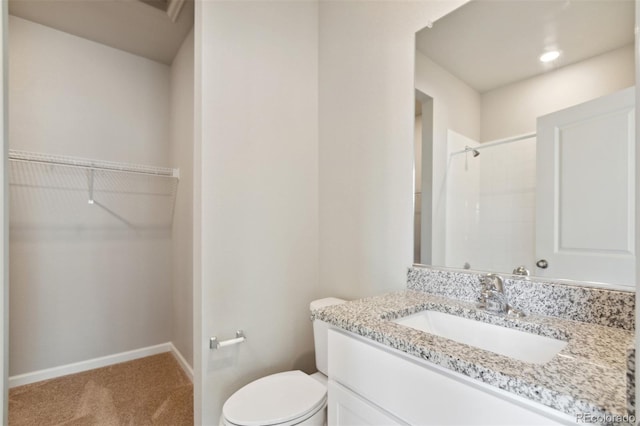 2320 Christina St, Fort Lupton, CO 80621 - full bath featuring vanity, a shower, toilet, a walk in closet, and baseboards