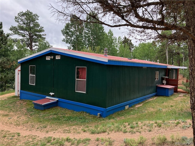 view of side of home with a lawn