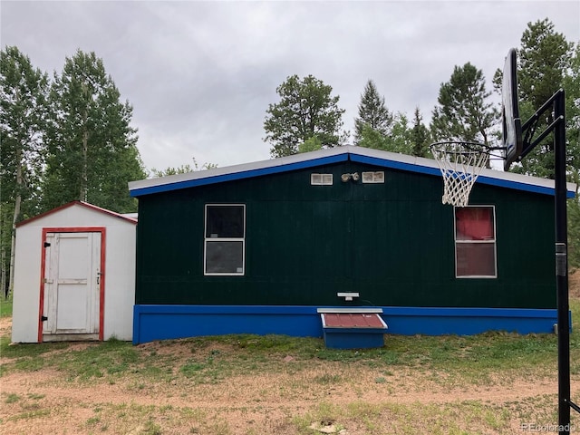 view of property exterior with a storage unit and a yard