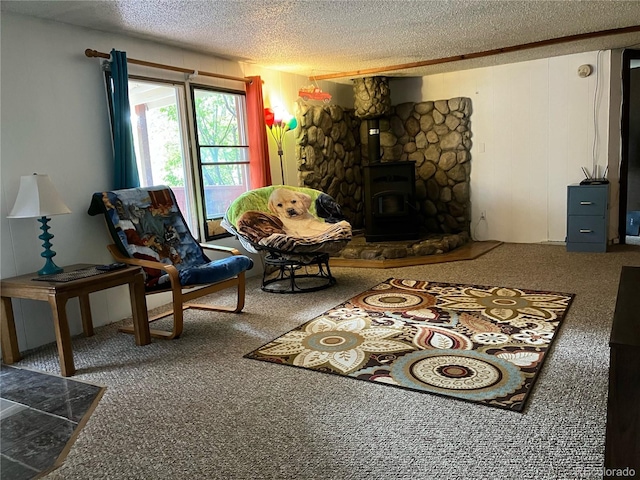 living room featuring carpet floors, a wood stove, and a textured ceiling