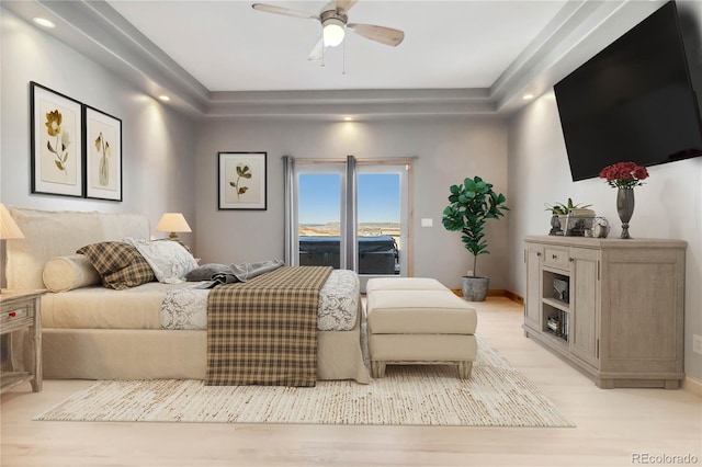 bedroom with ceiling fan, light wood-style flooring, and baseboards