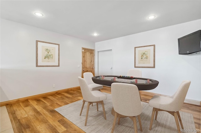 dining space with light wood-type flooring, baseboards, and recessed lighting