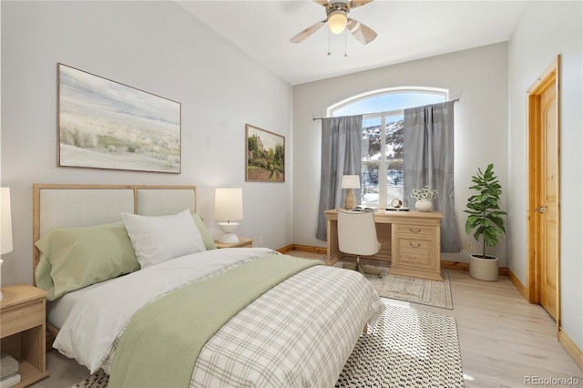 bedroom with light wood-type flooring, ceiling fan, and baseboards