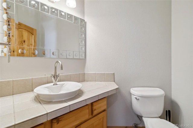 half bath featuring toilet and vanity