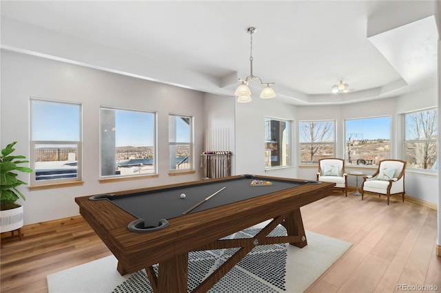 rec room featuring billiards, a raised ceiling, and light wood-style flooring