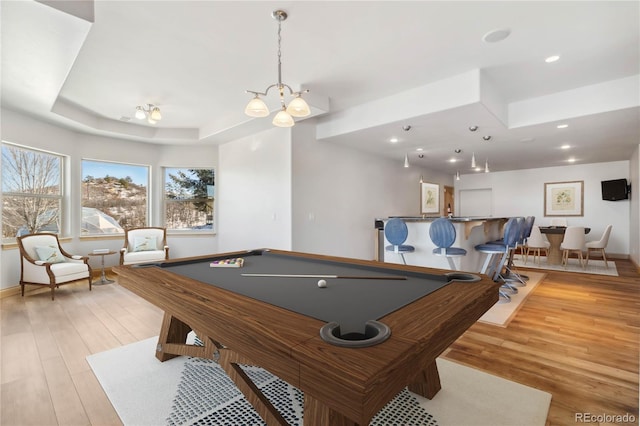 game room featuring billiards, baseboards, a tray ceiling, light wood-style floors, and recessed lighting