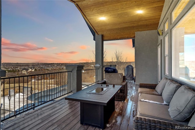 deck at dusk with an outdoor hangout area