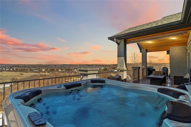 view of swimming pool featuring a hot tub