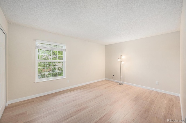 10251 W 44th Ave Unit 3-204, Wheat Ridge, CO 80033 - empty room with light wood-style flooring, a textured ceiling, and baseboards