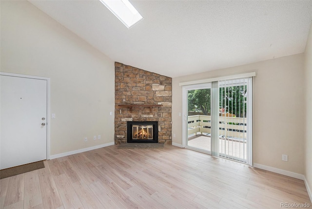 10251 W 44th Ave Unit 3-204, Wheat Ridge, CO 80033 - unfurnished living room with wood finished floors, a fireplace, baseboards, and high vaulted ceiling