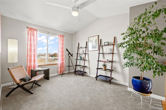 living area featuring vaulted ceiling, carpet, and ceiling fan