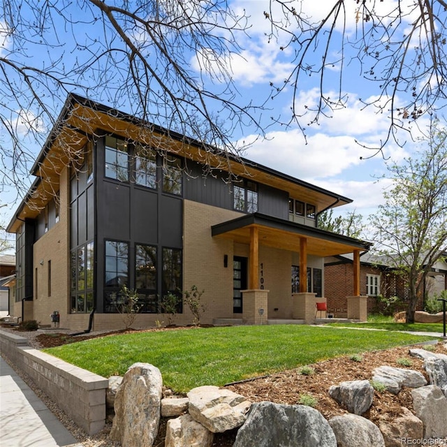 1100 S Elizabeth St, Denver, CO 80210 - rear view of property with a lawn and brick siding