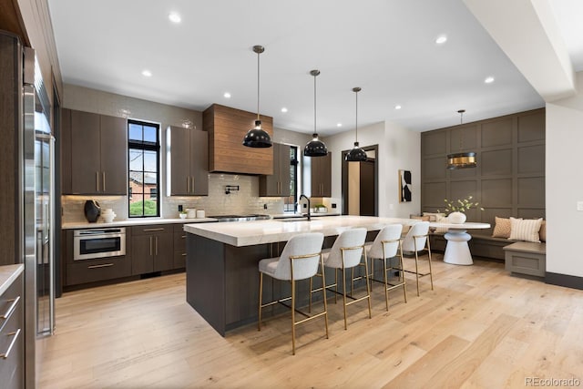 1100 S Elizabeth St, Denver, CO 80210 - kitchen featuring light wood-style floors, a sink, and light countertops