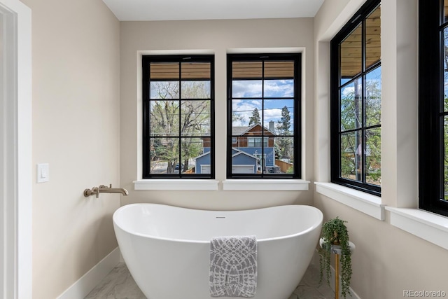 1100 S Elizabeth St, Denver, CO 80210 - full bath with a freestanding tub, baseboards, and marble finish floor