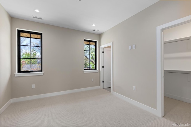 1100 S Elizabeth St, Denver, CO 80210 - unfurnished bedroom with light colored carpet, baseboards, visible vents, and a spacious closet