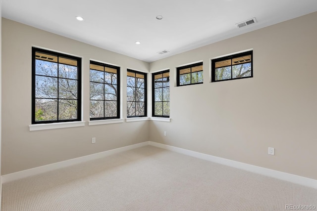 1100 S Elizabeth St, Denver, CO 80210 - unfurnished room featuring visible vents, plenty of natural light, and light colored carpet