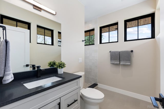1100 S Elizabeth St, Denver, CO 80210 - full bath featuring walk in shower, tile patterned flooring, vanity, toilet, and baseboards