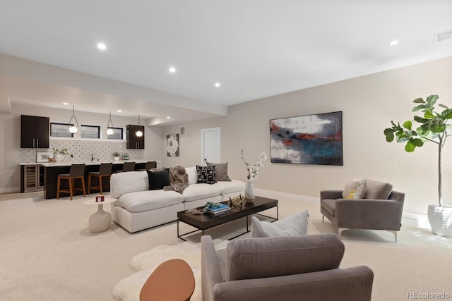 1100 S Elizabeth St, Denver, CO 80210 - living room featuring light colored carpet, recessed lighting, wet bar, and baseboards