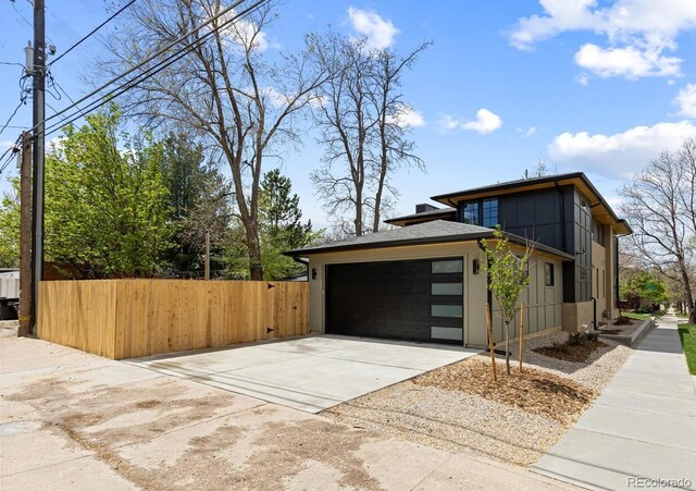 1100 S Elizabeth St, Denver, CO 80210 - view of side of home featuring fence, an attached garage, and concrete driveway